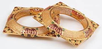 22K bangles with lotus design with kalkatti and meenakari work and studded with red & green stones